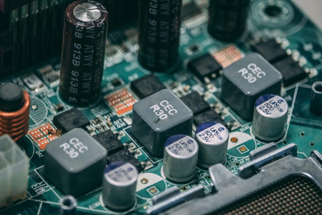 Detailed view of electronic components on a circuit board showcasing capacitors and semiconductors.